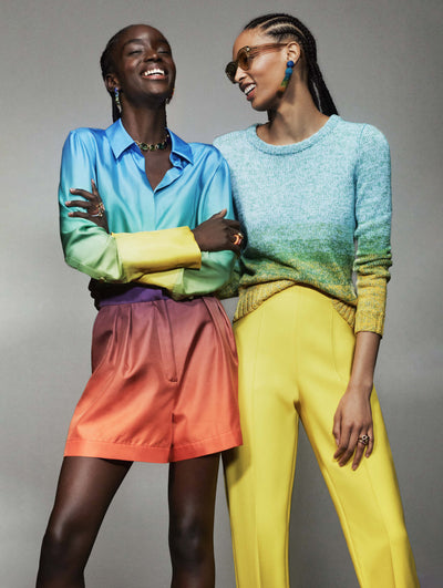 Two models pose against a grey backdrop in Oscar de la Renta ombre ready-to-wear looks. 