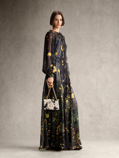 The model is wearing a navy long sleeve dress with an abstract yellow dotted pattern. 