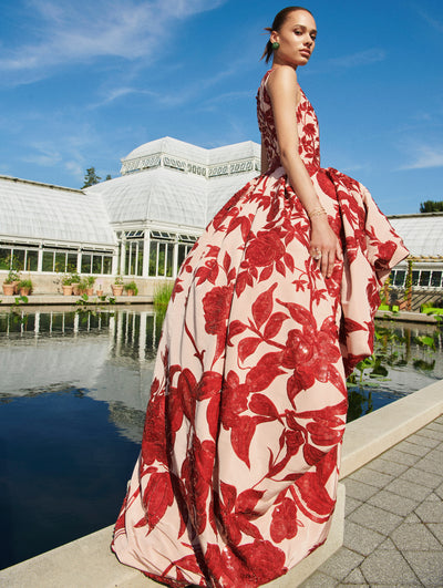 A model poses outside in an Oscar de la Renta floral embroidered gown. 