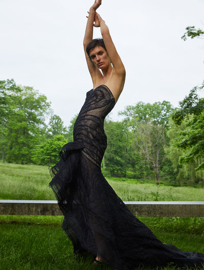 A model wears a black lace gown