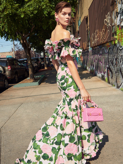 A model poses outside in an Oscar de la Renta hydrangea floral gown. 