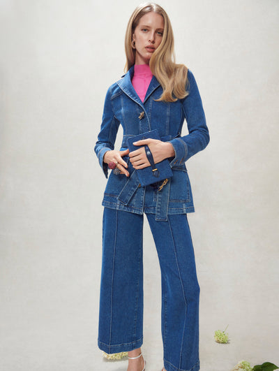 A model poses inside in an Oscar de la Renta denim suit. 