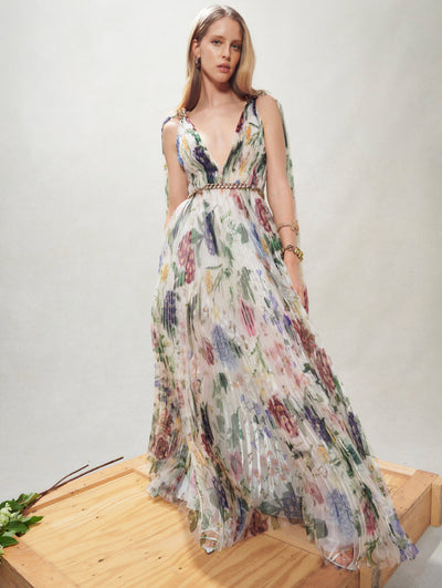 A model poses inside in an Oscar de la Renta floral gown. 