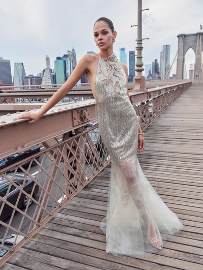 A model poses outside in an Oscar de la Renta crystal embroidered gown. 