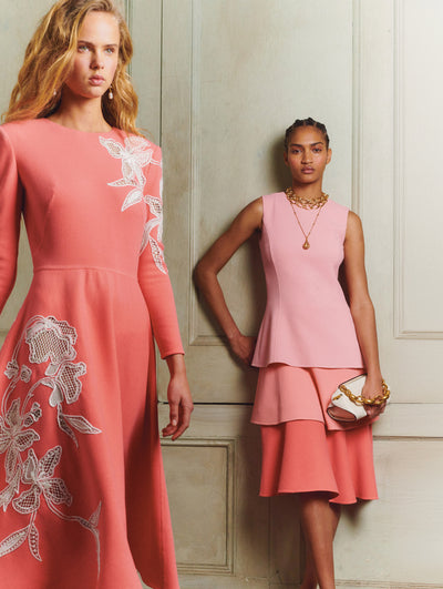Two models both are wearing pink dresses
