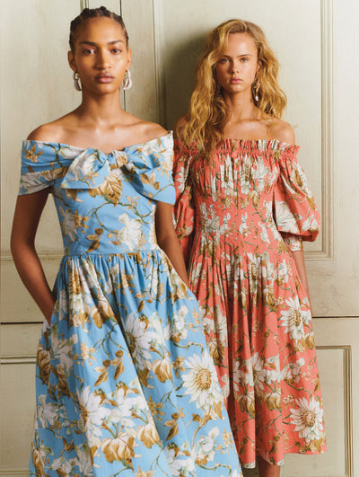 Two models both are wearing flower printed dresses