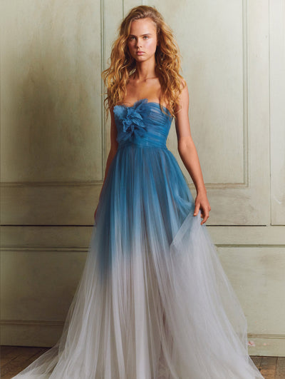 A model wears a long blue tulle gown