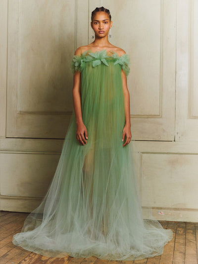 A model wears a long green tulle gown