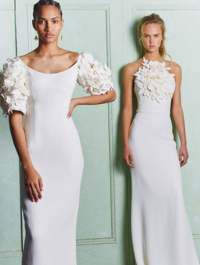 Two models; both are wearing white dresses