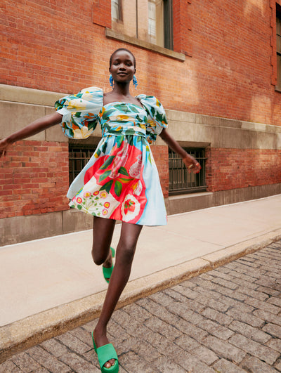 A model runs towards the camera in an Oscar de la Renta floral cotton poplin day dress. 