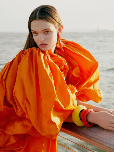 A model poses in an Oscar de la Renta orange caftan. 