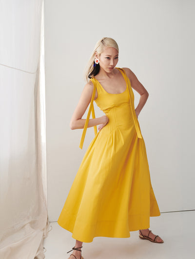A model wears a yellow dress