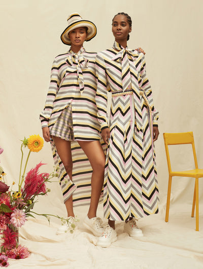 Two models wear a colorful striped set