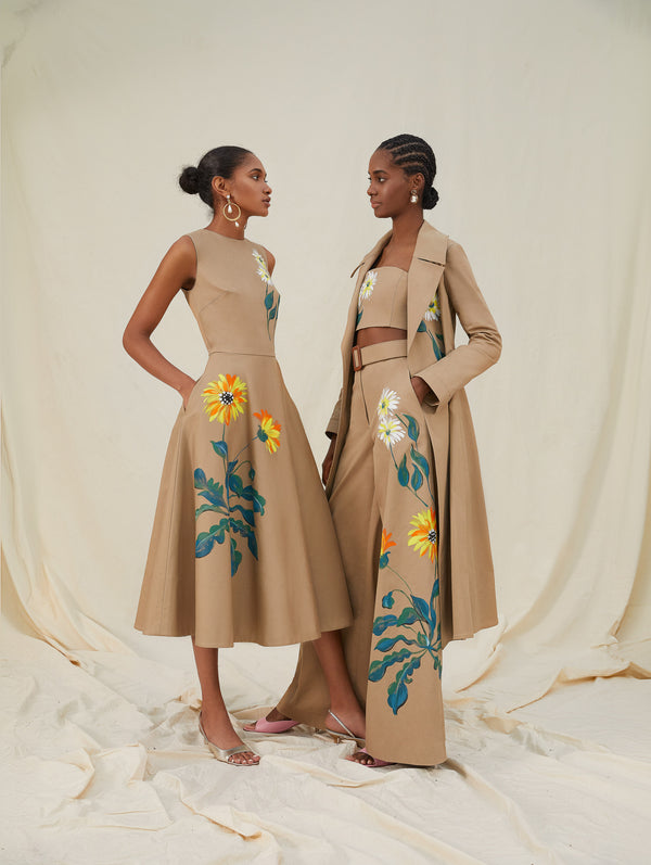Two models wear khaki items with flowers printed