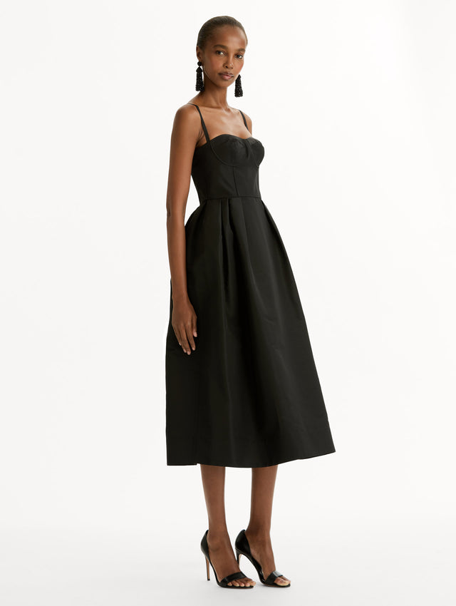 Black Bustier-Detailed Faille Dress with thin straps, a bustier bodice, and midi length skirt. Side View.