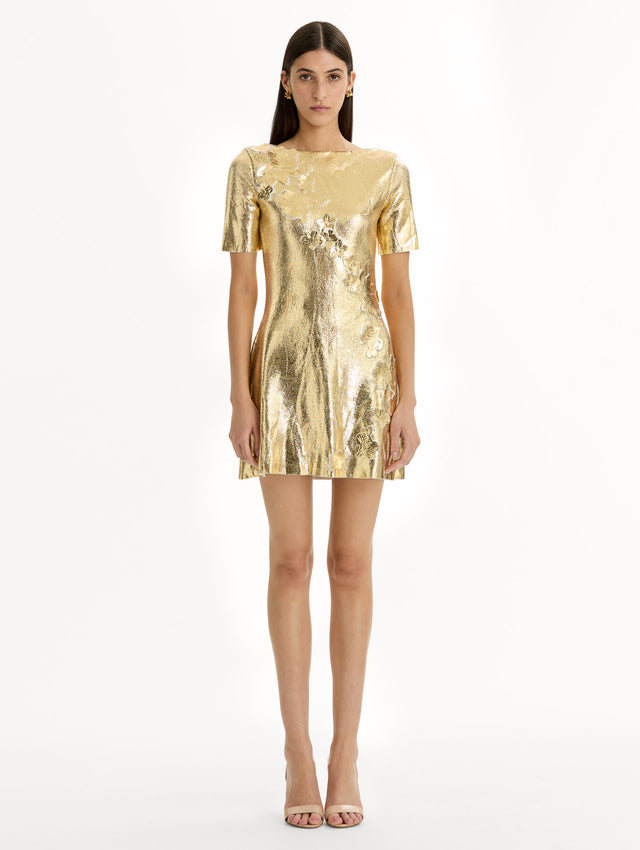 Metallic gold sleeveless mini dress with cherry blossom lace embroidery. Front view.