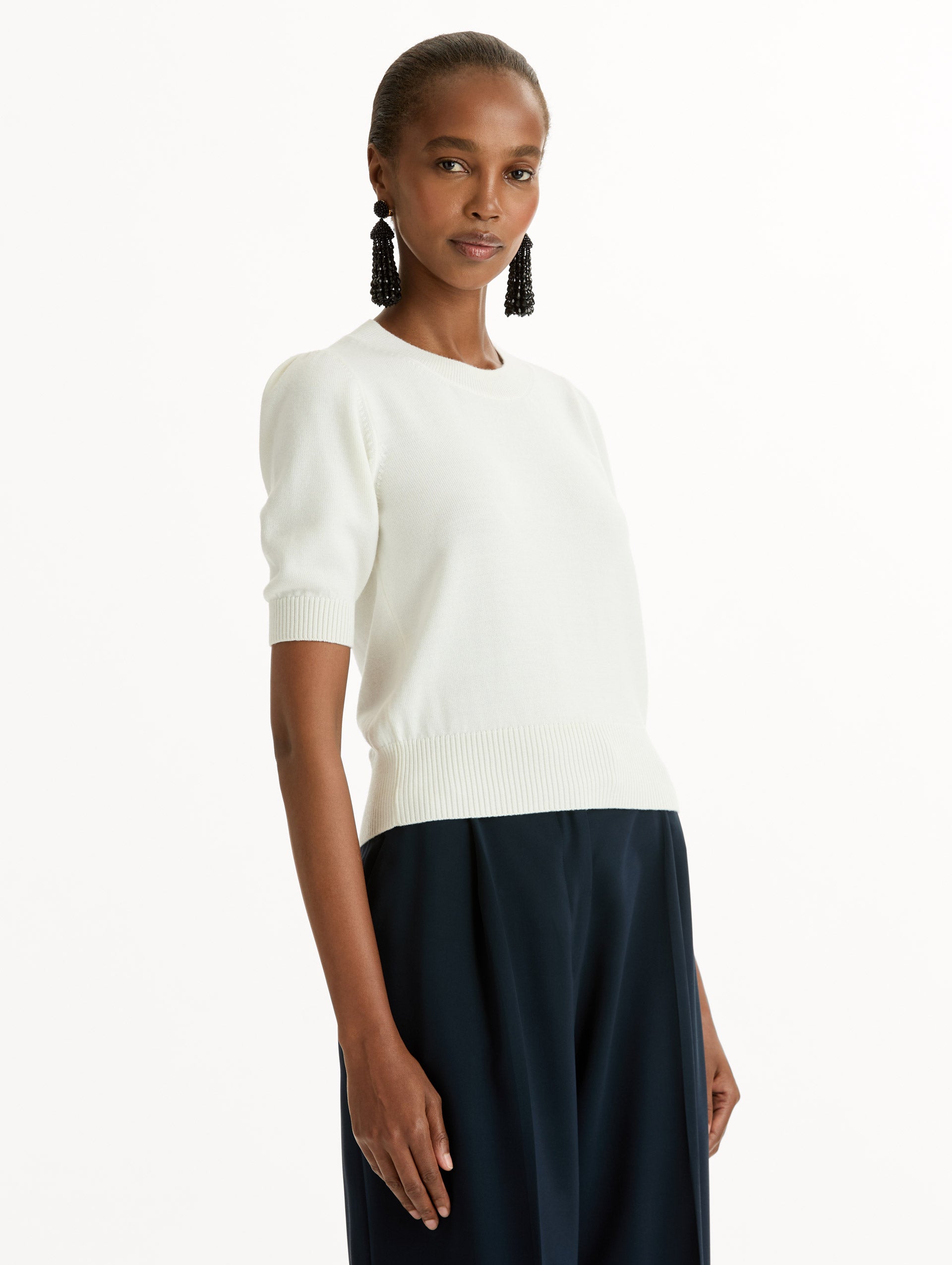 Ivory Short Sleeve Wool Pullover with ribbed neckline and hem. Side View.