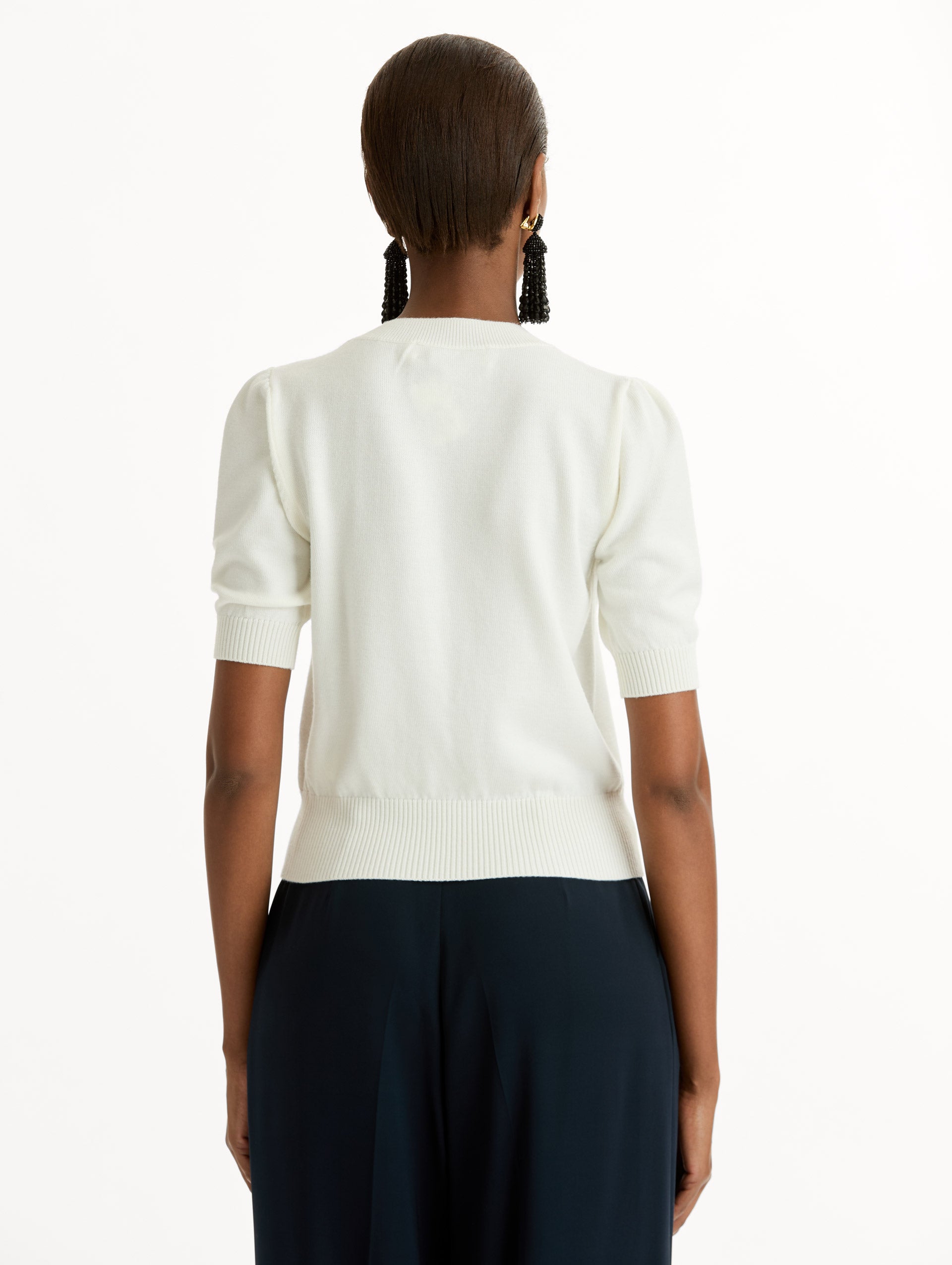 Ivory Short Sleeve Wool Pullover with ribbed neckline and hem. Back View.