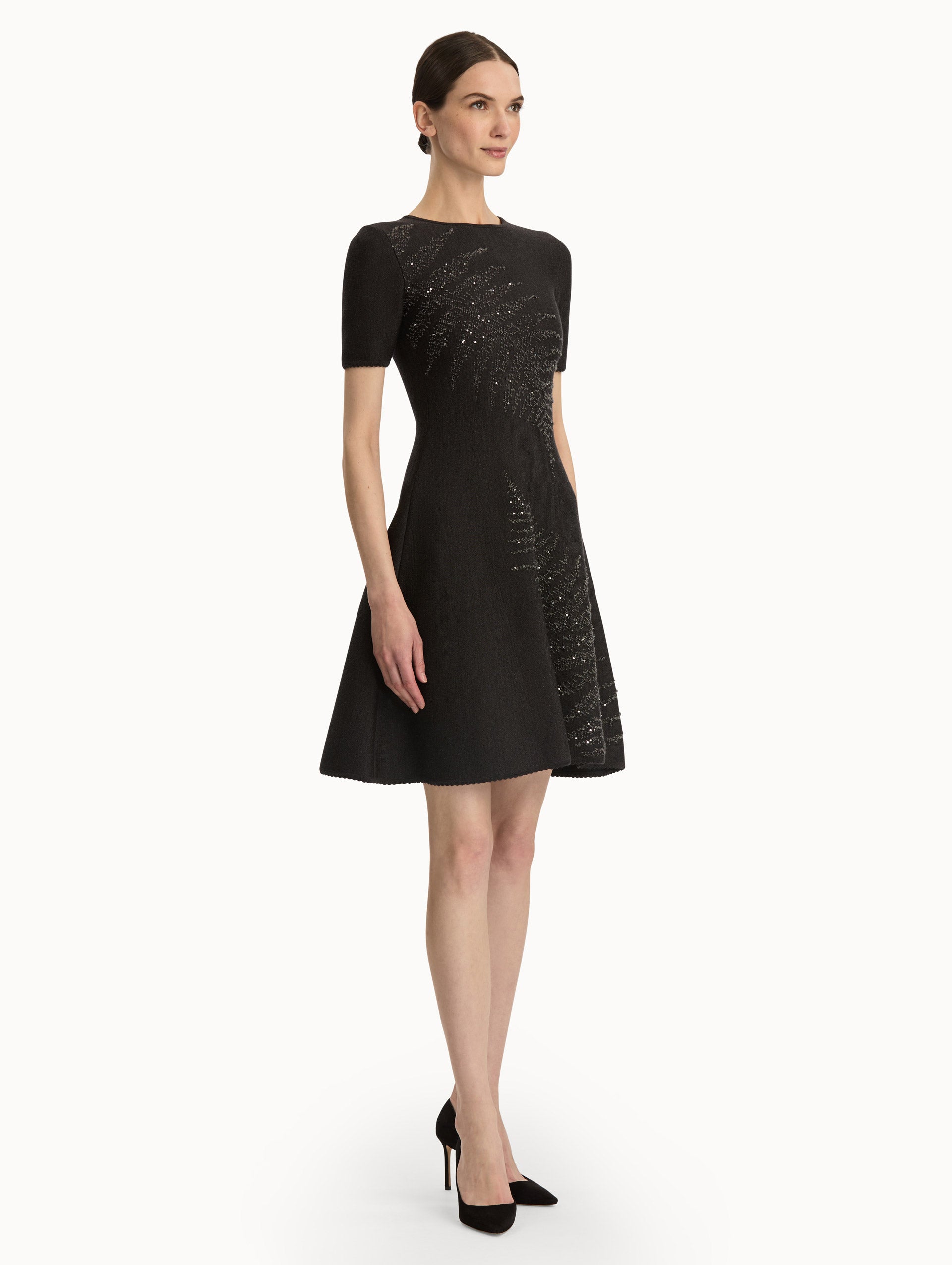 Charcoal short sleeve dress with silver sequin fern embroidery. Side view.