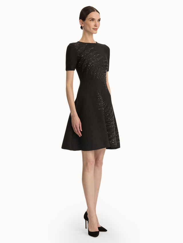 Charcoal short sleeve dress with silver sequin fern embroidery. Side view.