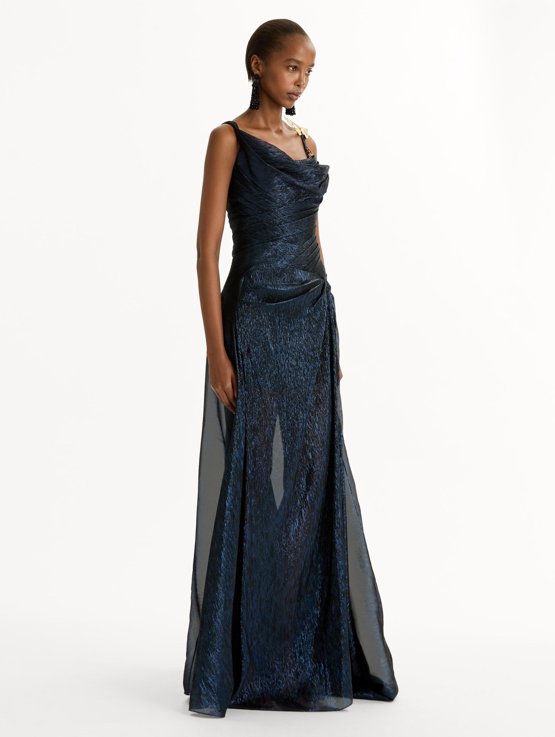 Navy Lamé Mousseline Draped Gown with gold butterfly hardware on the shoulder and asymmetric draped bodice. Side View. 