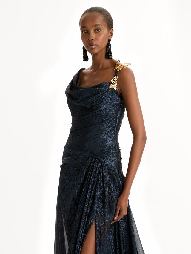 Navy Lamé Mousseline Draped Gown with gold butterfly hardware on the shoulder and asymmetric draped bodice. Zoom View. 