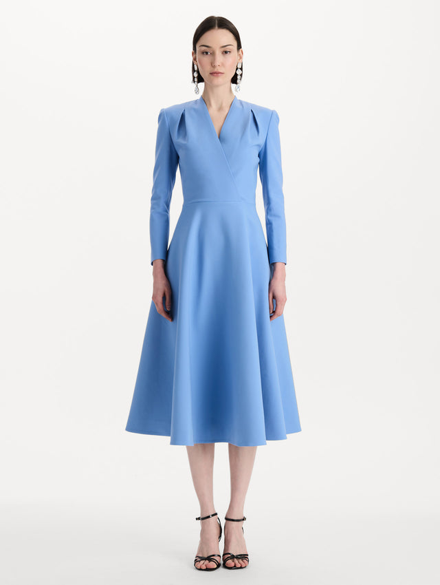 The model is wearing the Wool-Blend Long-Sleeve Dress in the color Hydrangea blue. Featuring a sculpted wrap bodice, long sleeves, and a flared skirt. Front View.