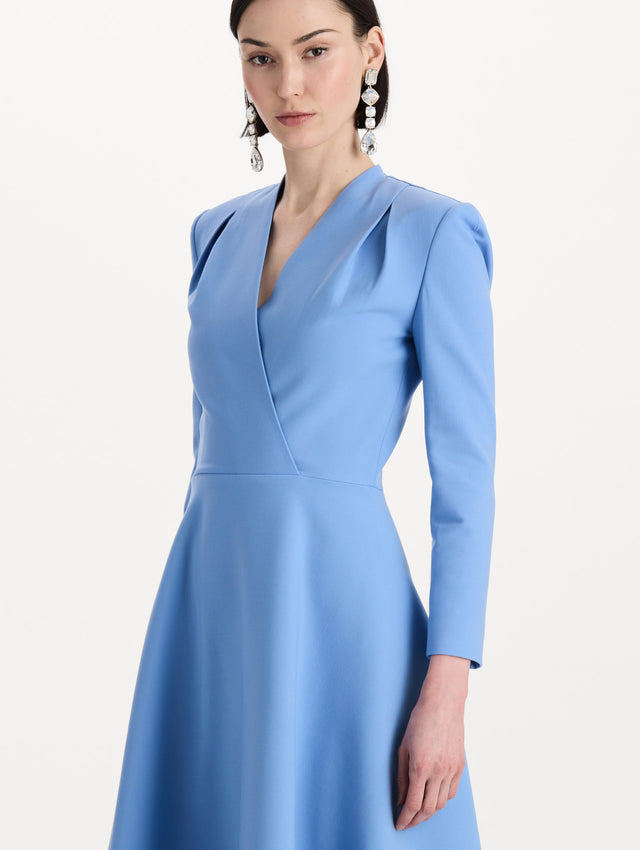 The model is wearing the Wool-Blend Long-Sleeve Dress in the color Hydrangea blue. Featuring a sculpted wrap bodice, long sleeves, and a flared skirt. Detail Shot.