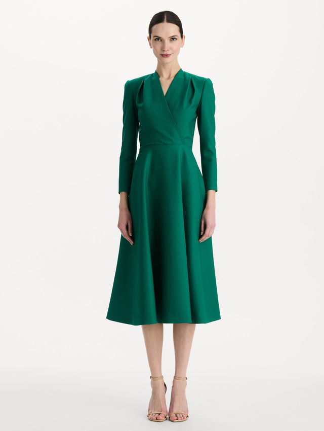 The model is wearing the Wool-Blend Long-Sleeve Dress in the color Malachite green. Featuring a sculpted wrap bodice, long sleeves, and a flared skirt. Front View.