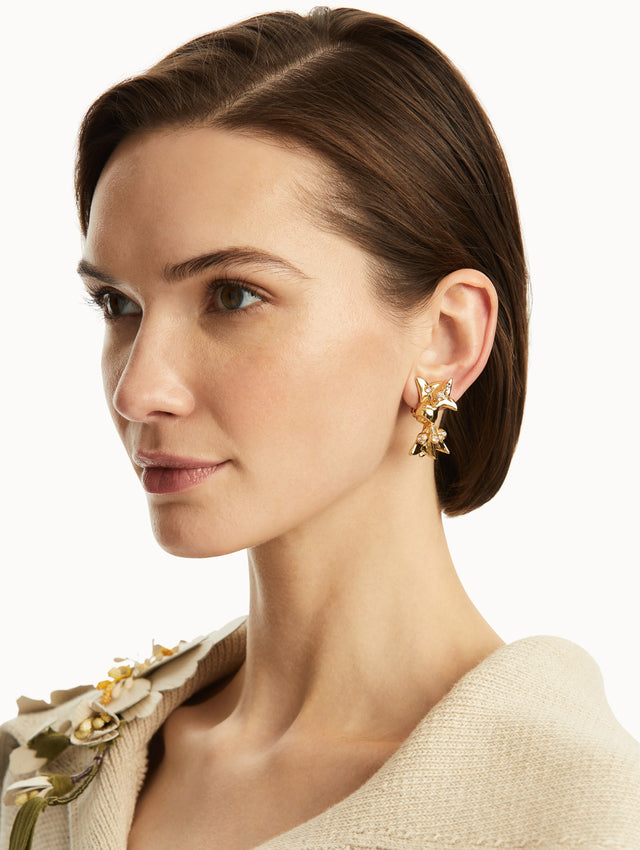 Gold mill bow earrings. Front view.