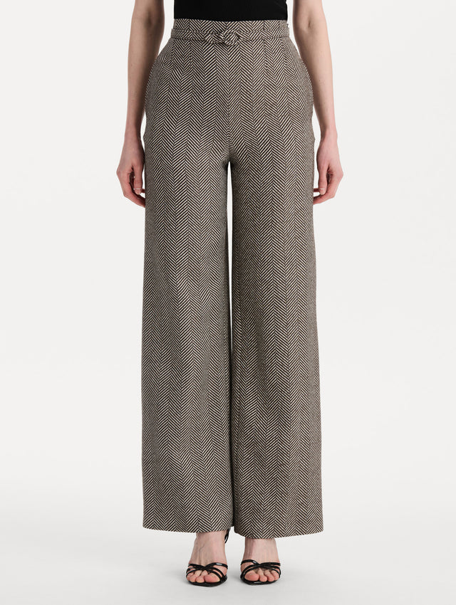 The model is wearing the Chevron Cashmere-Blend Pant featuring a high waist, pockets, and coordinating belt. Front View.