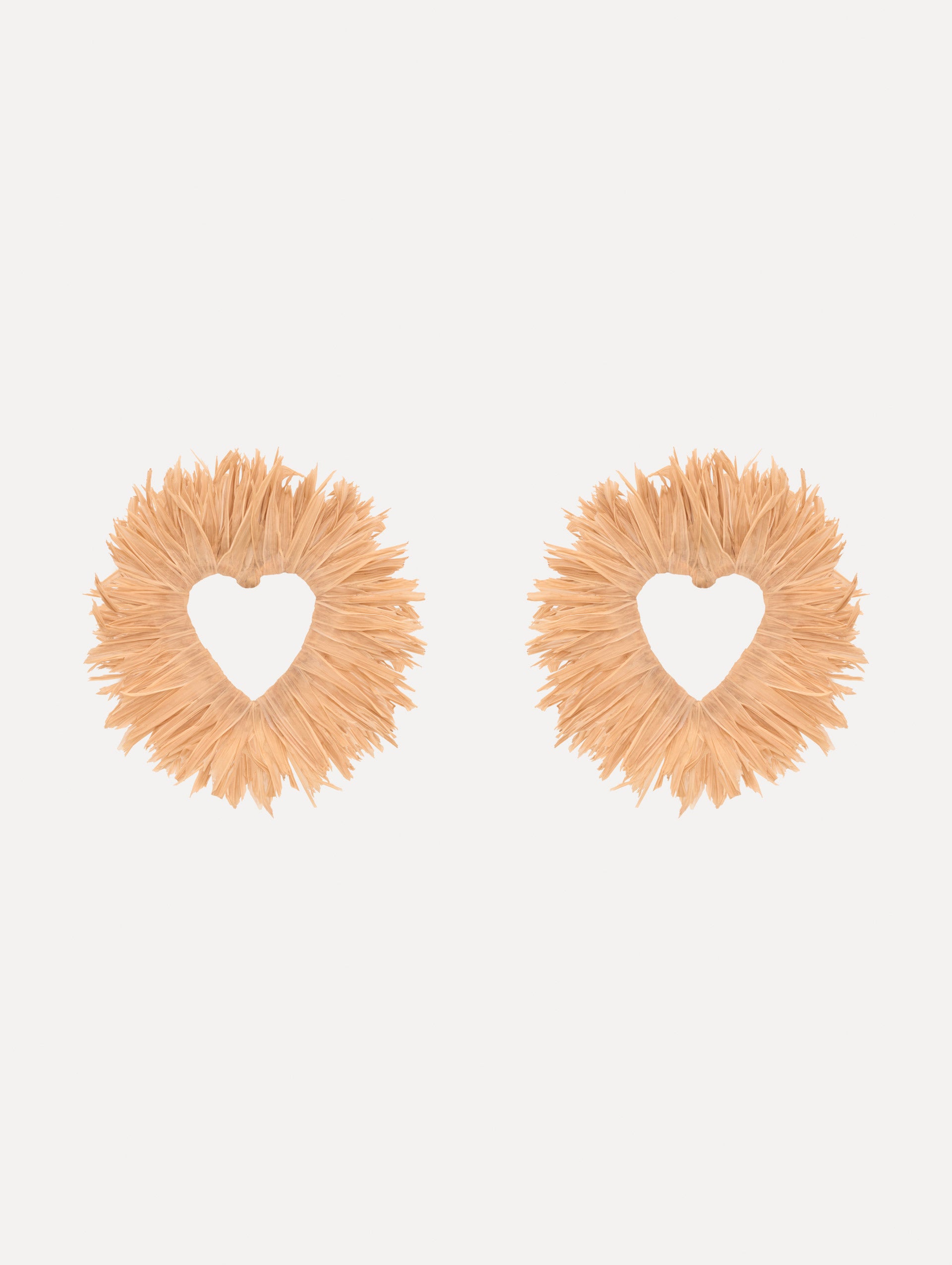The Raffia Heart Earrings with heart cut-out center. Front View.