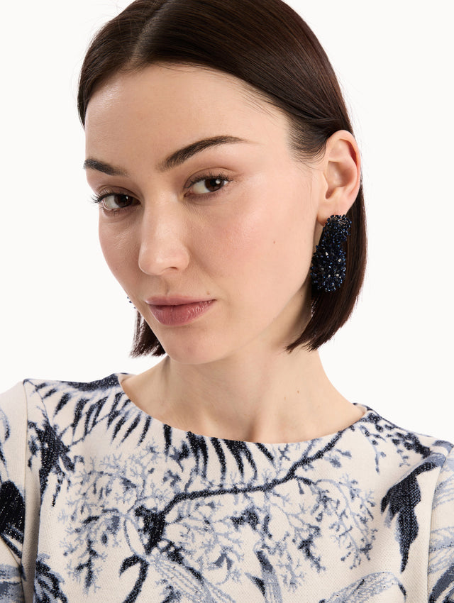 The model is wearing the Beaded Cluster Drop Earrings in Navy. Detail View.