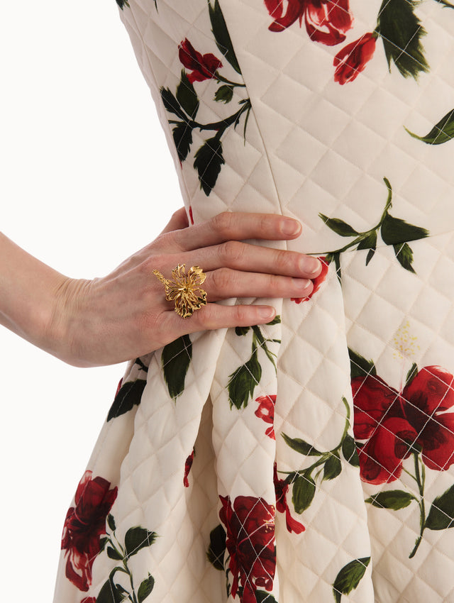 The model is wearing the Openwork Hibiscus Ring in Gold. Detail View.