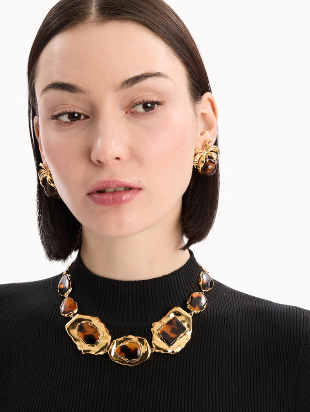 The model is wearing the Tortoise Stone Collar Necklace in Gold and Tortoise. Front View.
