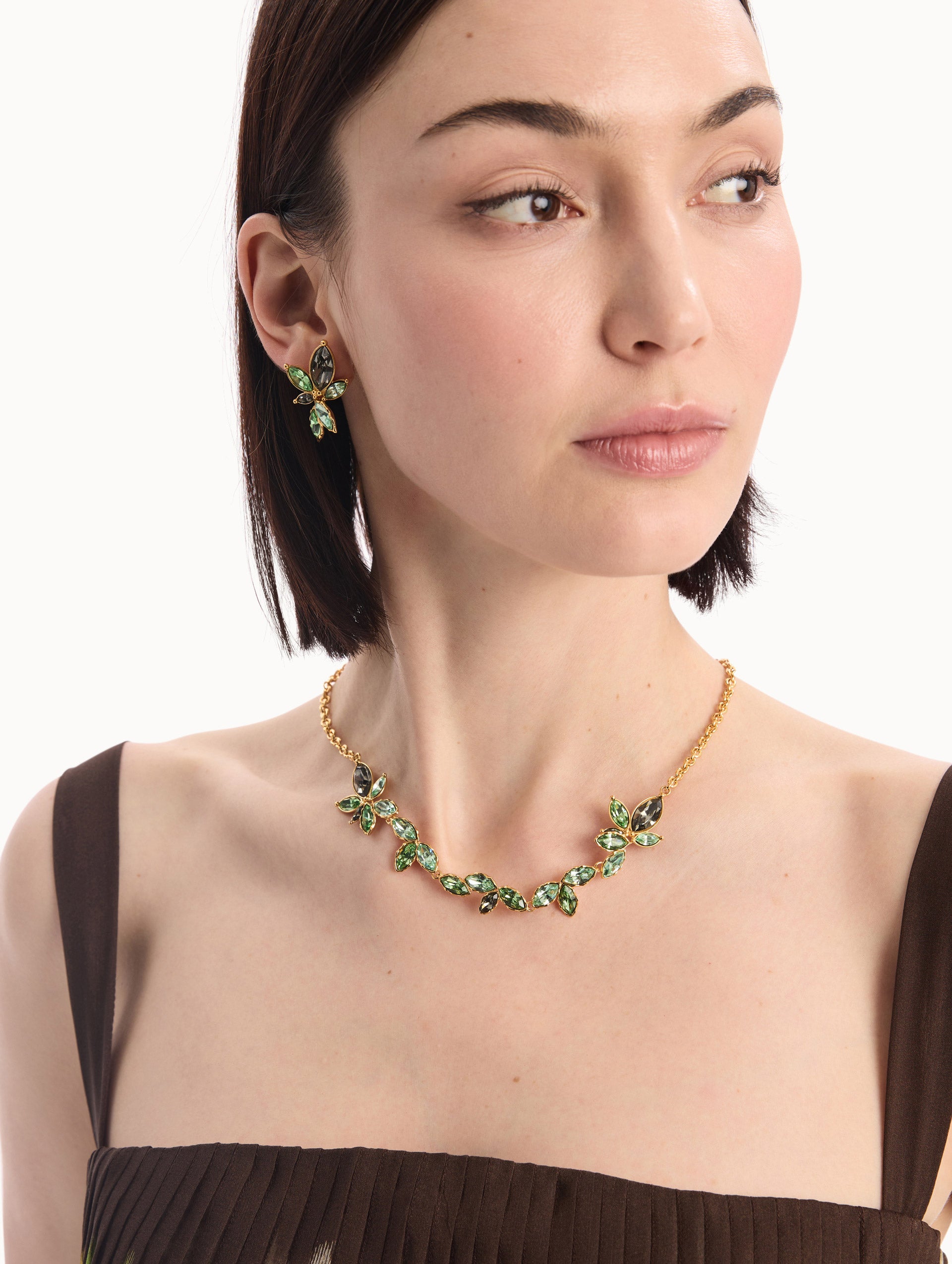 The model is wearing the Navette Crystal Necklace in Peridot. Front View. 