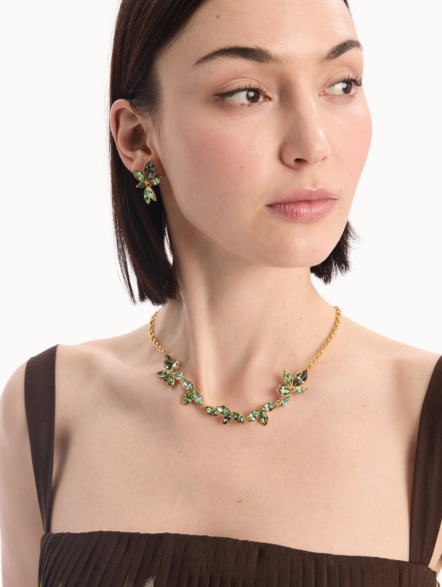 The model is wearing the Navette Crystal Necklace in Peridot. Front View. 