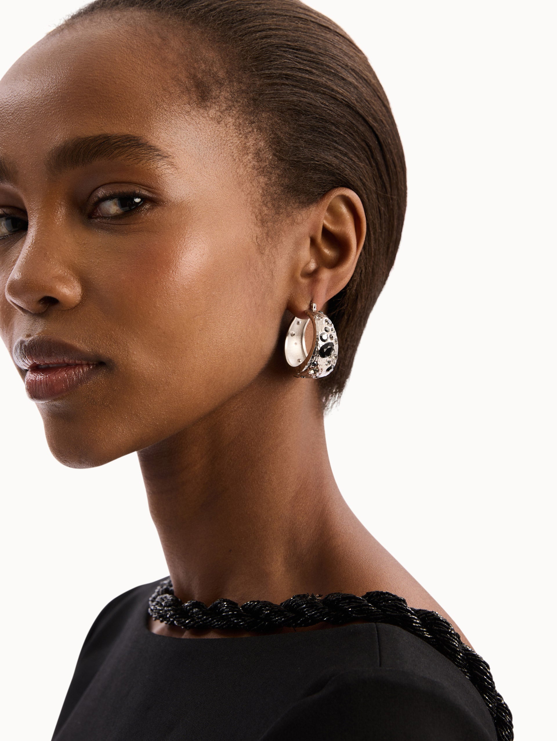 The model is wearing the Mixed Crystal Hoop Earrings. Detail View.