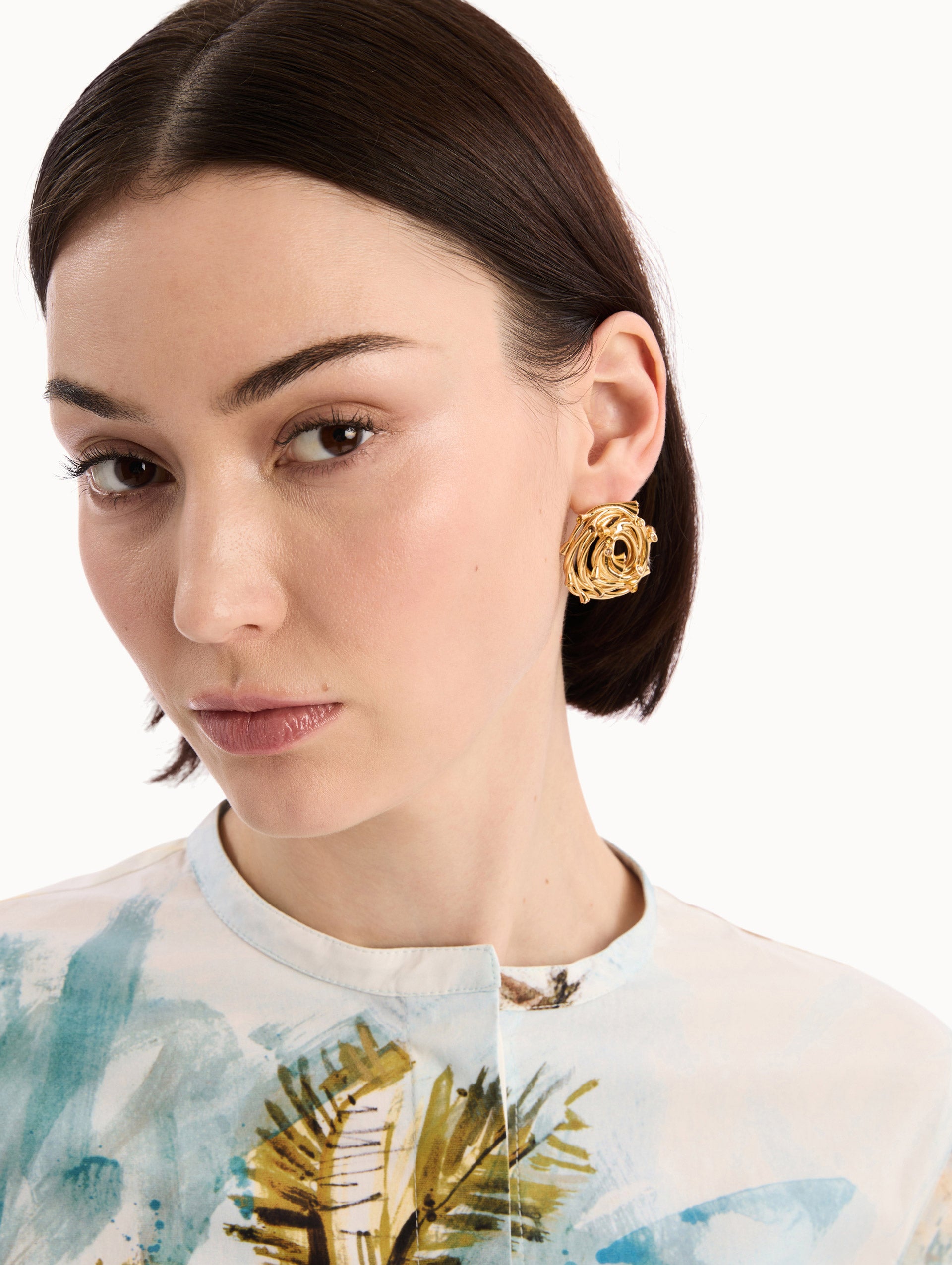 The model is wearing the Rhinestone Nest Earrings. Detail View.