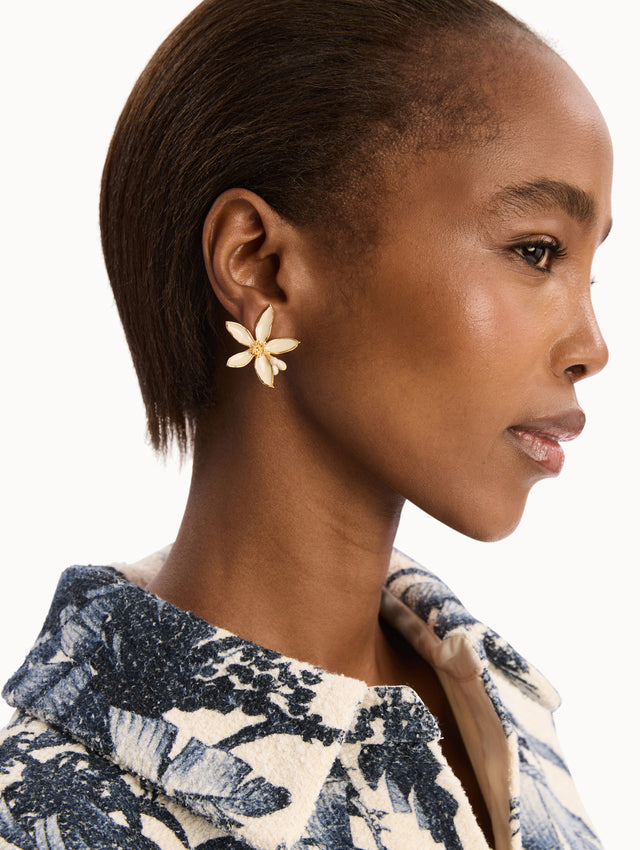 The model is wearing the Orange Blossom Earrings in White. Detail View.