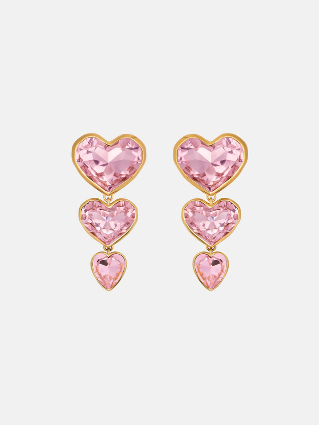 The Crystal Heart Drop Clip-On Earrings in Pink. Three vertically connected hearts with gold rims. Front View.