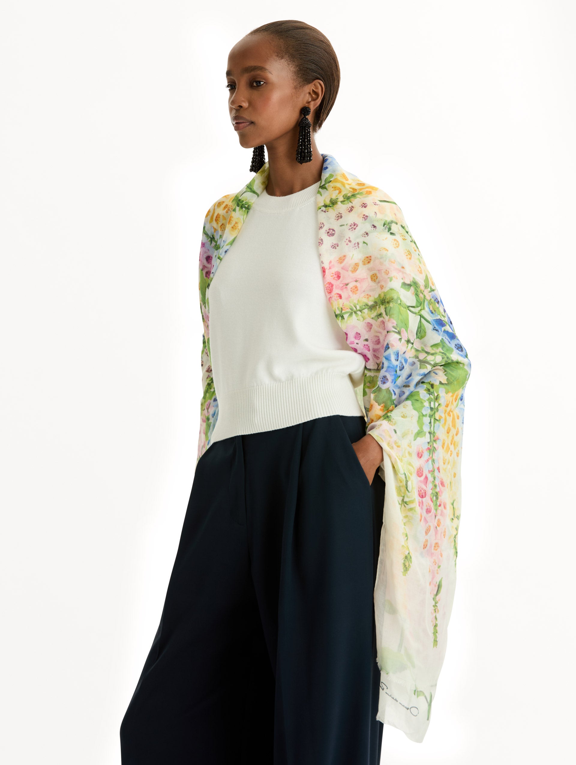 Floral Allium Modal Scarf featuring multicolor foxglove motifs on a white background with signature logo detail. Side View.