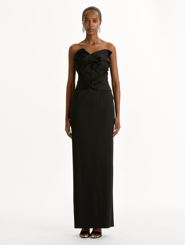 Black dress with bow detailing and a strapless, asymmetric neckline. Front View.