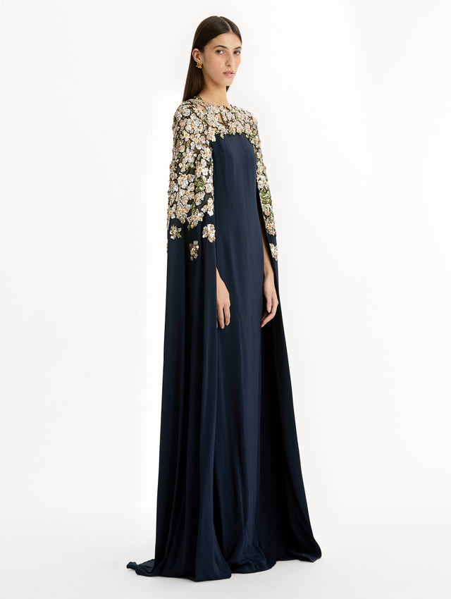 Navy Floral Sequin Embroidered Caftan with floor length caped sleeves and floral sequin embroidery. Side View.