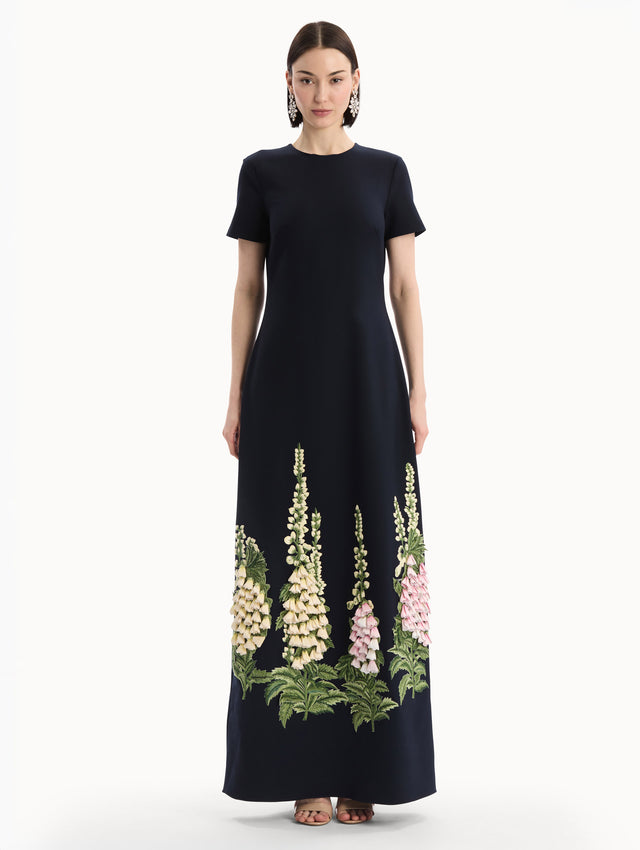 The model is wearing the Foxglove Embroidered Caftan in Navy with  three-dimensional threadwork embroidery. Front View.