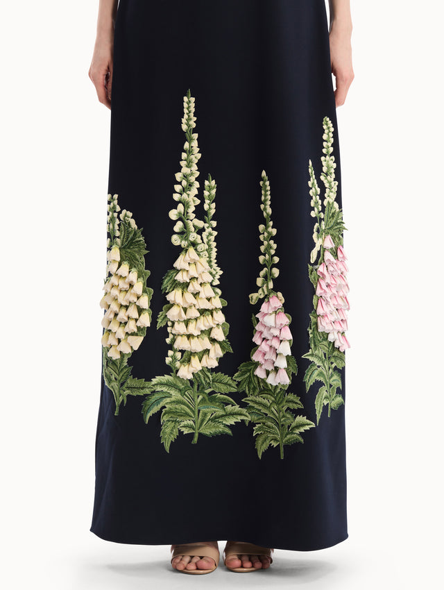 The model is wearing the Foxglove Embroidered Caftan in Navy with  three-dimensional threadwork embroidery. Front View.