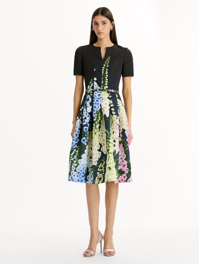 Black floral Degradé Foxglove Split-Neck Dress with belted waist and short sleeves. Front View.