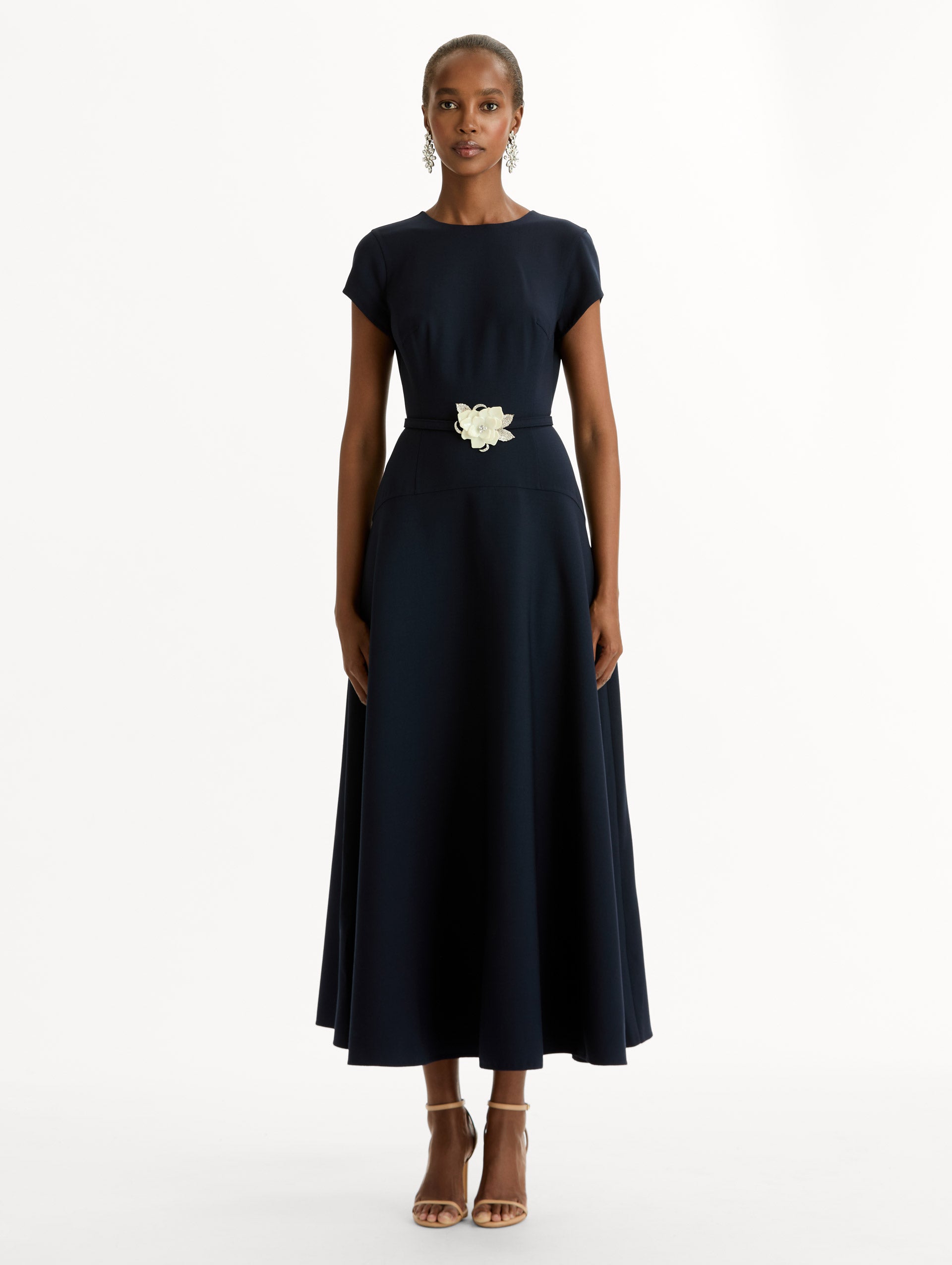 Navy Floral Belt Short Sleeve Dress with short sleeves and a belted waist featuring a white floral accent. Front View.