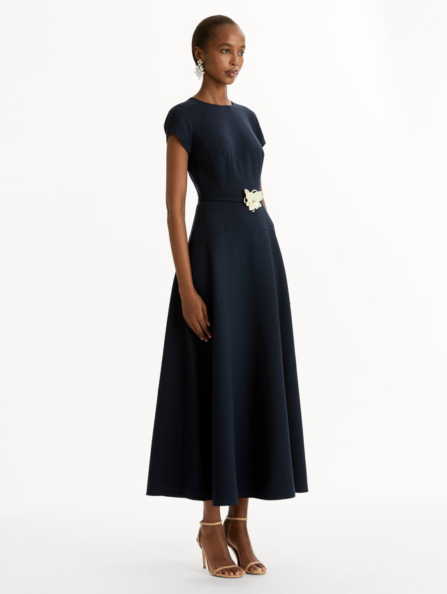 Navy Floral Belt Short Sleeve Dress with short sleeves and a belted waist featuring a white floral accent. Side View.