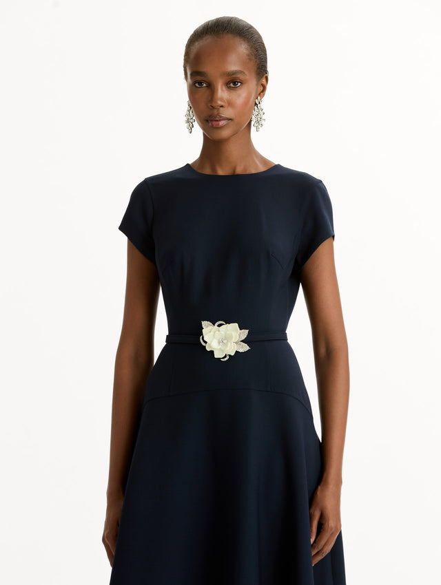 Navy Floral Belt Short Sleeve Dress with short sleeves and a belted waist featuring a white floral accent. Zoom View.